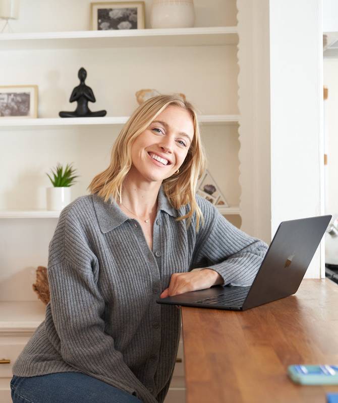 woman smiling at computer