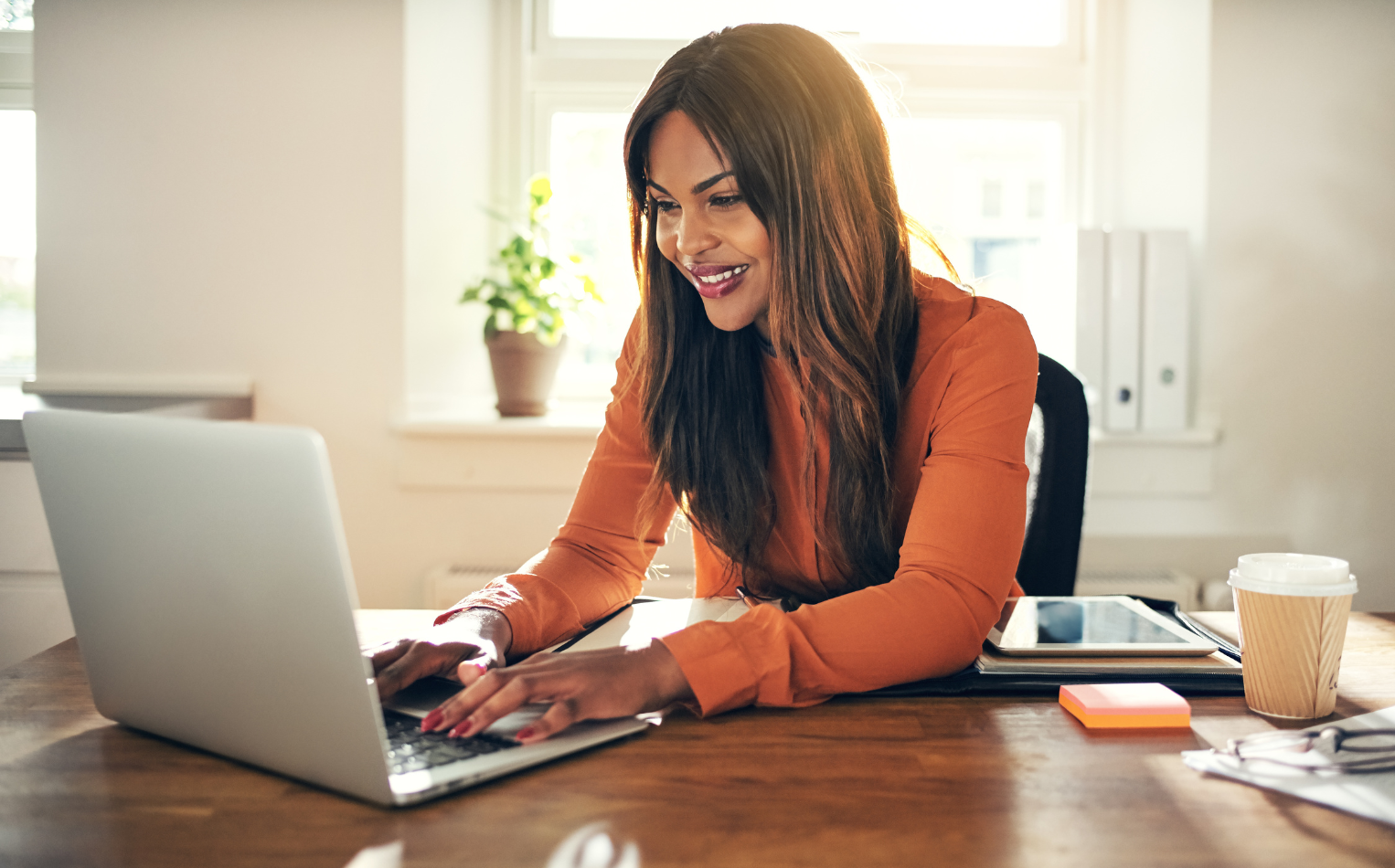 happy worked at desk smiling at computer