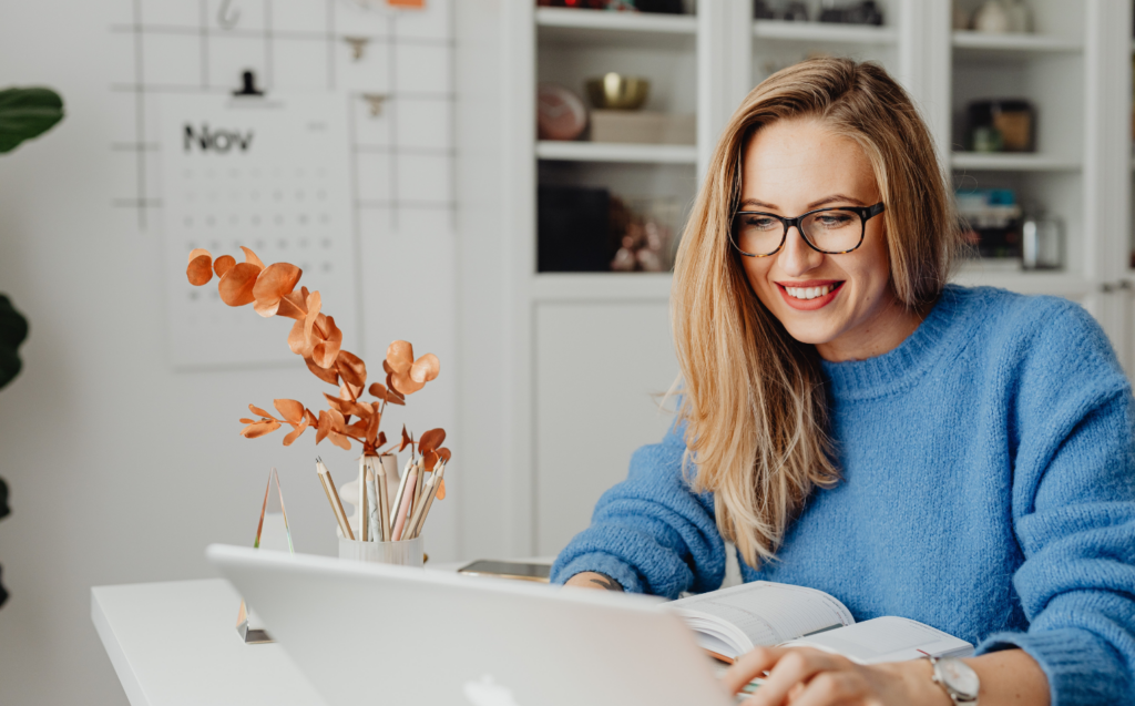 employee working from home smiling at laptop