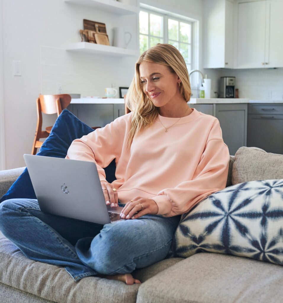 woman smiling at computer screen