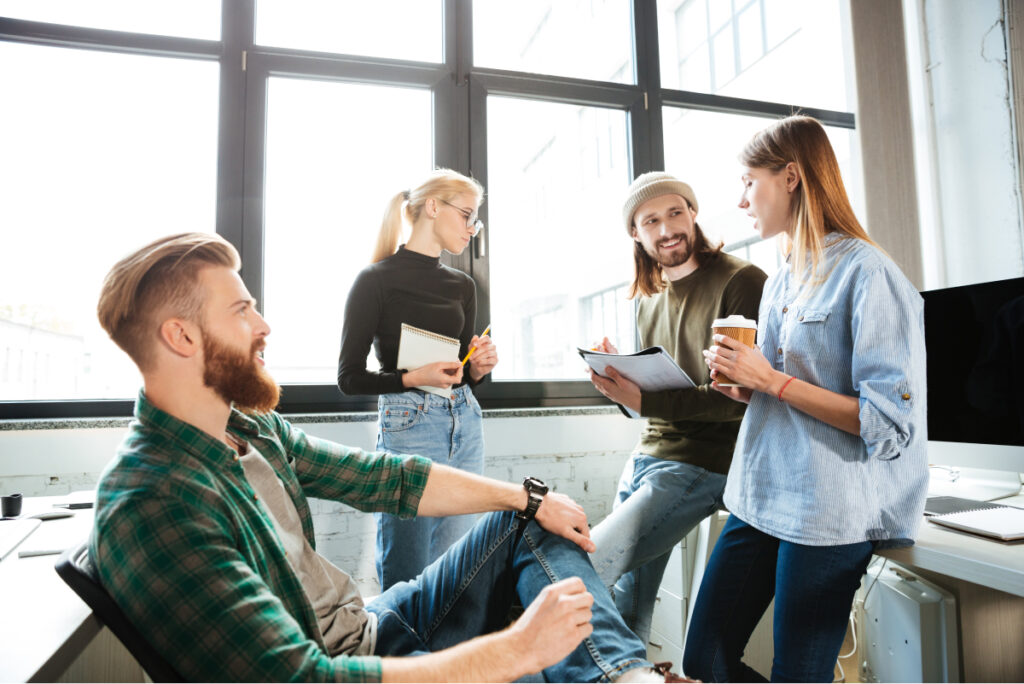 colleagues standing office talking with each other